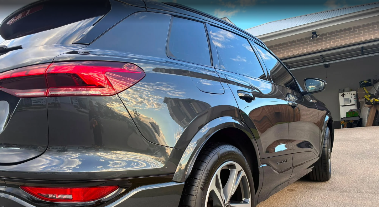 Back view of a black SUV parked in a garage.