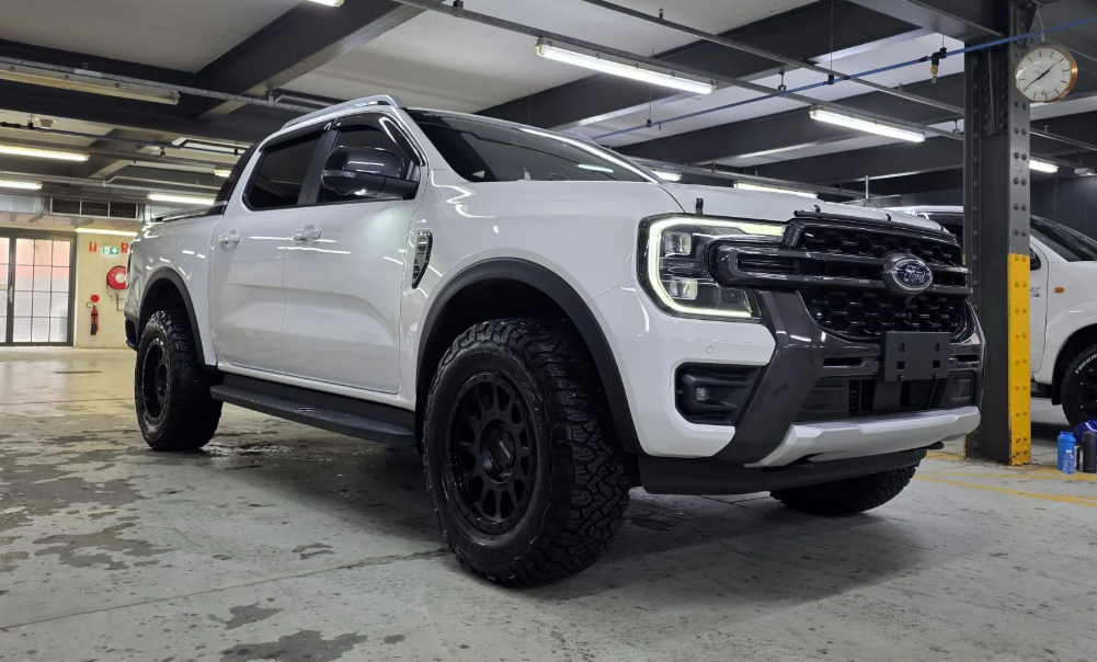 White Ford pickup truck in a garage setting