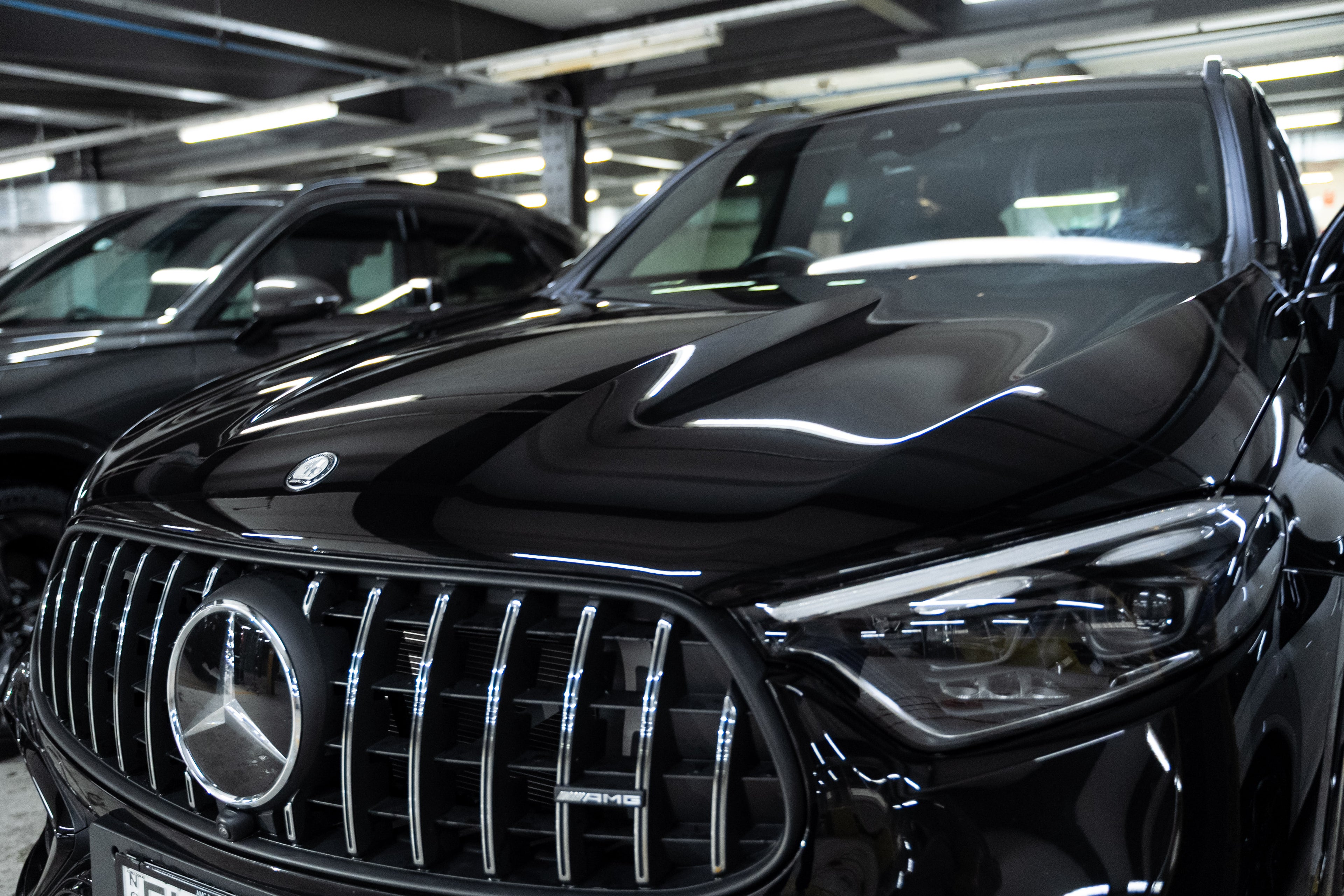 Black Mercedes SUV with professionally tinted windows inside the GenTek workshop.