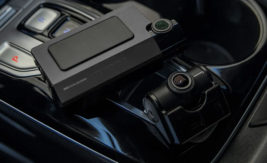 Front and rear dash camera system displayed inside a modern vehicle.