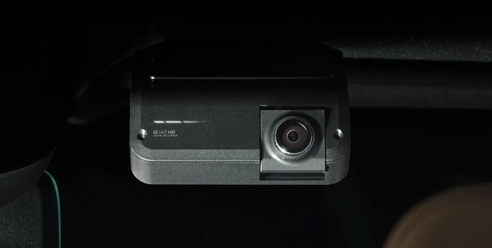 Rear-facing dash camera professionally installed inside a vehicle.
