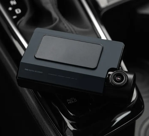 Dash camera system displayed on the centre console inside a vehicle.