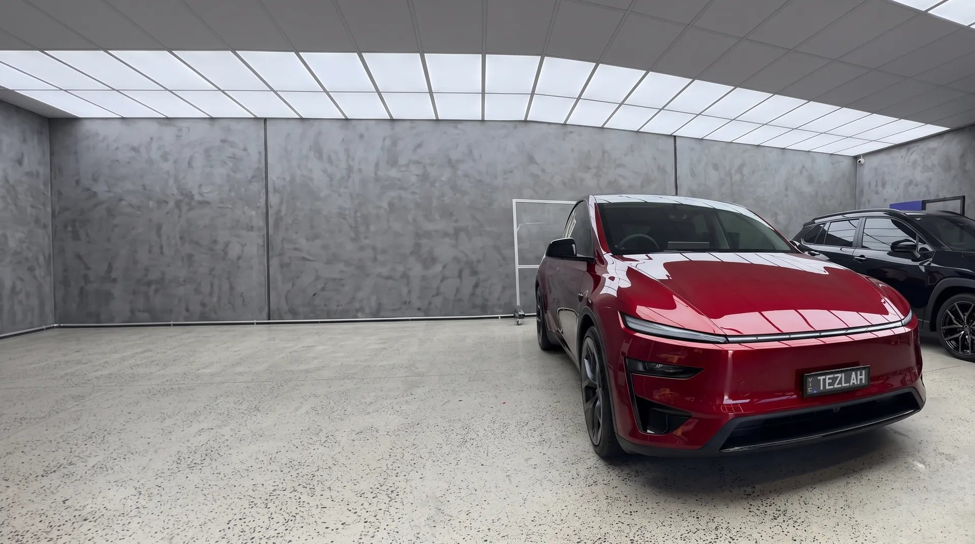 A red Tesla Model Y in GenTek's workshop bay